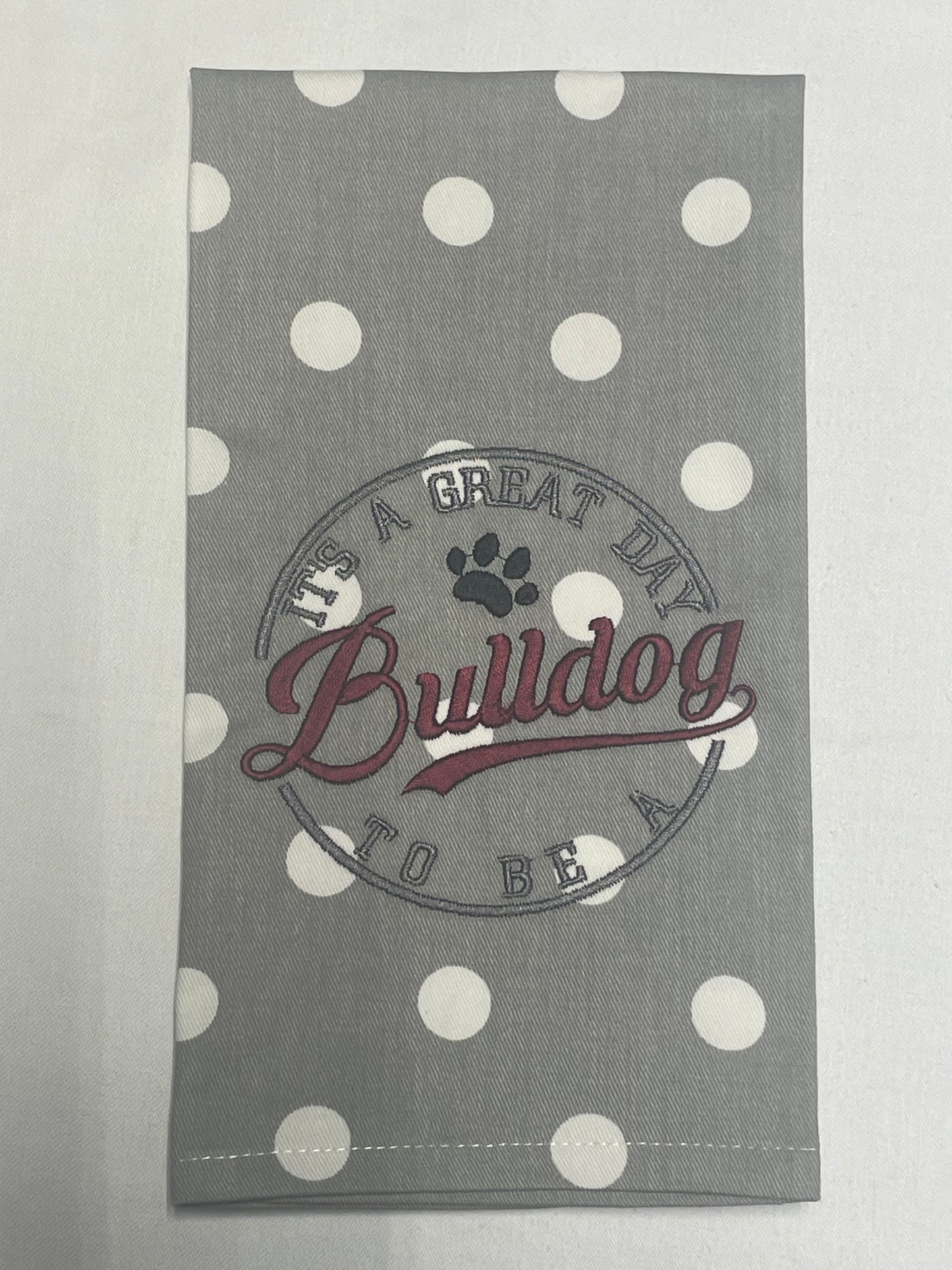 Hand towel featuring embroidered "It's a great day to be a Bulldog" text with paw print design on gray and white polka dot fabric, perfect for Mississippi State fans and college sports decor.