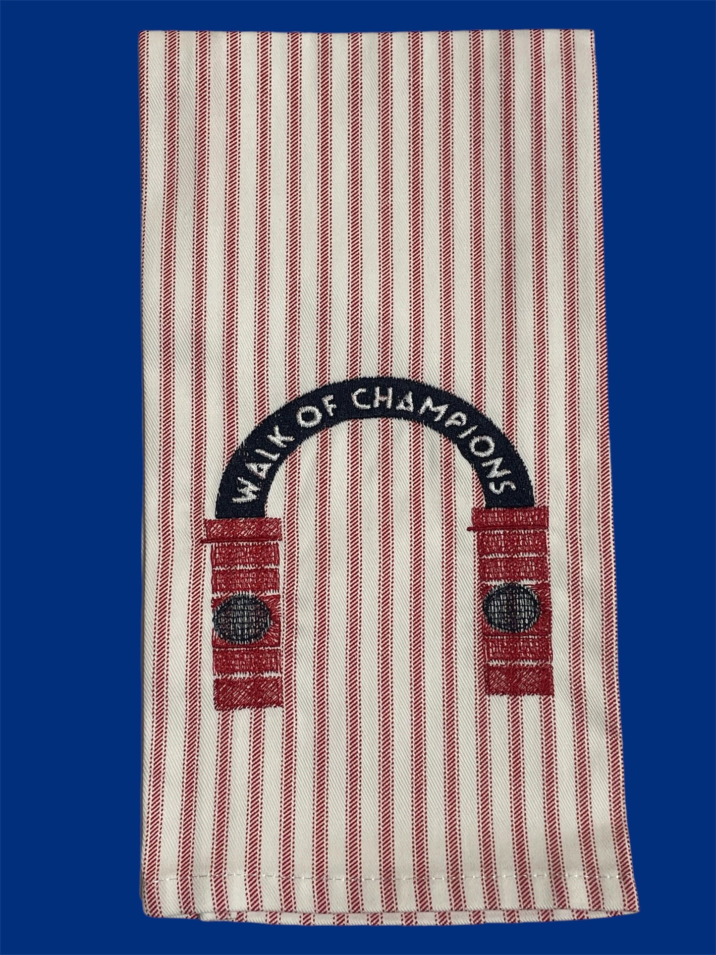 Decorative hand towel featuring embroidered Walk of Champions archway design on red and white striped fabric, representing Ole Miss tradition, ideal for tailgates, kitchens, or game day decor.