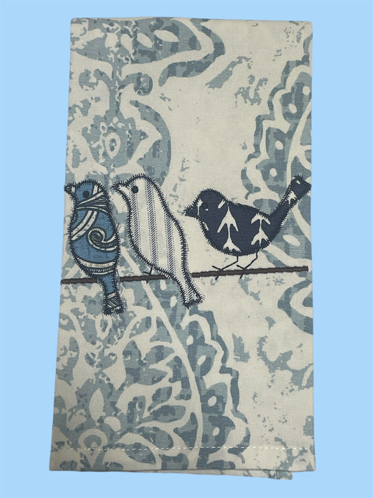 Decorative hand towel featuring embroidered blue birds on a branch with floral patterned background, perfect for spring and farmhouse-style kitchen decor.