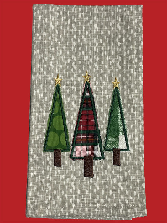 Christmas kitchen towel with three embroidered Christmas trees in green and plaid patterns, each topped with a gold star, perfect for holiday kitchen decor.