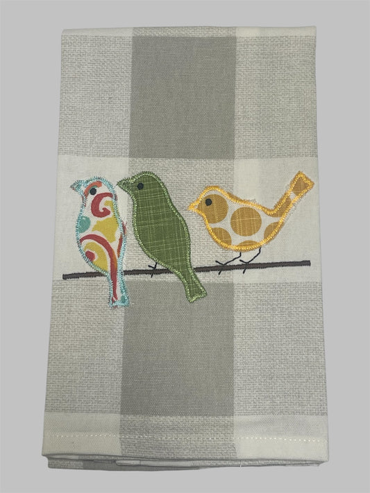 Decorative hand towel featuring three embroidered colorful birds on a branch, perfect for spring, nature, or farmhouse-themed kitchen decor.