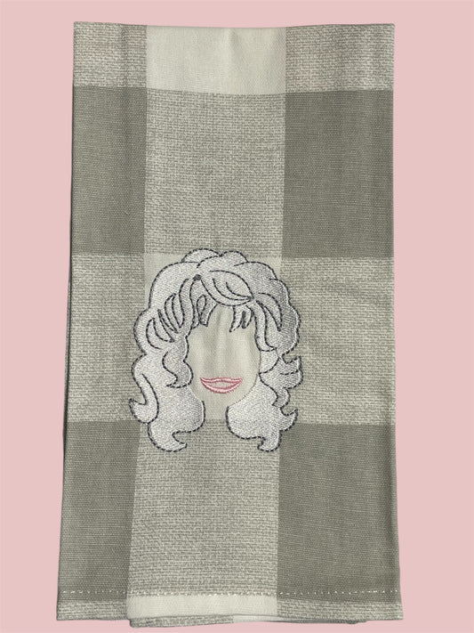 Decorative hand towel featuring embroidered silhouette of Dolly Parton’s hair and smile on a gray buffalo check background, perfect for country music fans, Southern kitchens, and gift ideas.