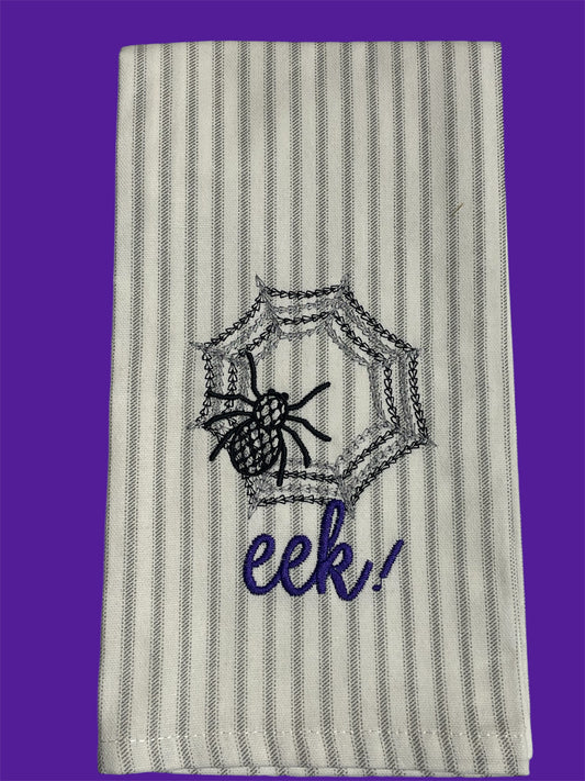 Striped hand towel featuring embroidered black spider on web with purple "eek!" text, perfect for Halloween decor and seasonal kitchen or bathroom accents.