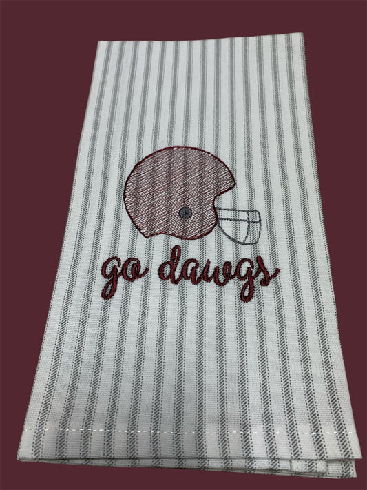Hand towel with embroidered maroon football helmet and "go dawgs" text on gray and white striped background, perfect for Mississippi State Bulldogs fans and gameday decorations.