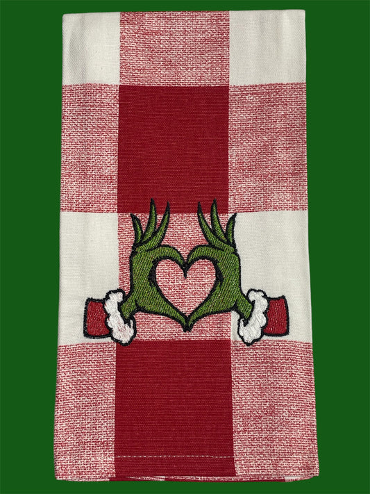 Decorative hand towel featuring embroidered Grinch-inspired green hands forming a heart on red and white checkered background, perfect for Christmas holiday decor.