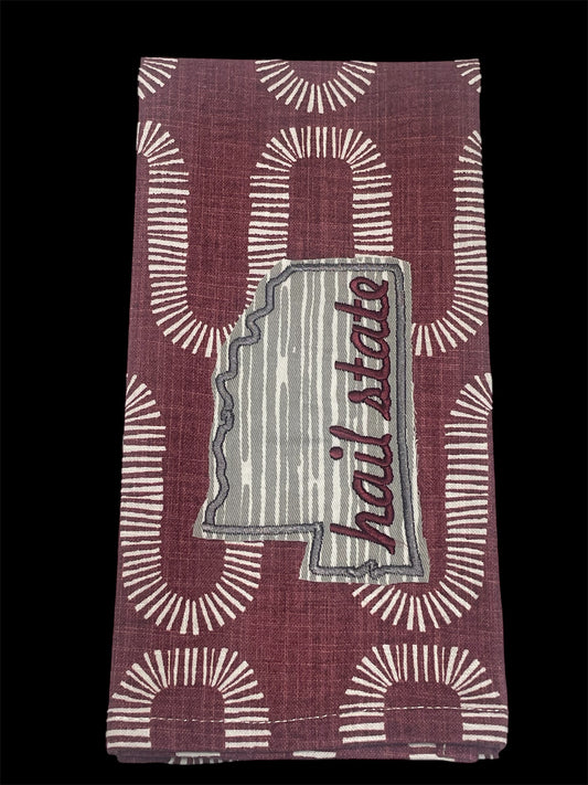 Decorative hand towel featuring embroidered Mississippi state outline with “Hail State” text on maroon patterned background, perfect for Mississippi State fans and game day decor.