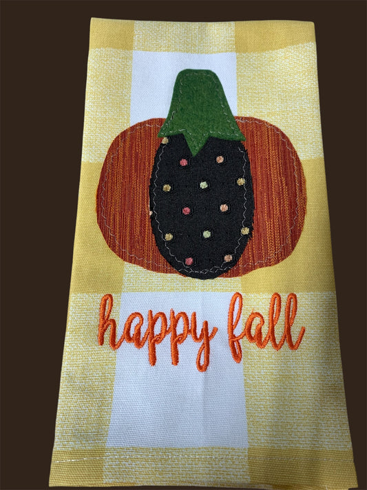 Decorative hand towel featuring embroidered pumpkin with colorful polka dots and “Happy Fall” text on yellow checkered background, perfect for autumn and seasonal kitchen decor.