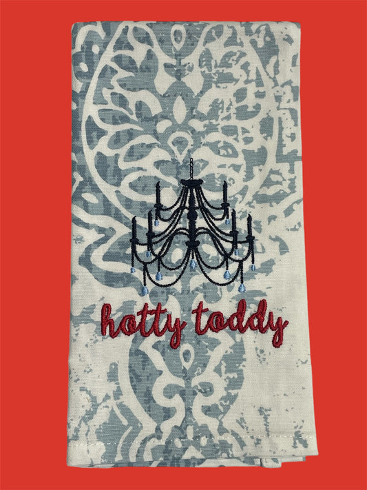 Decorative hand towel featuring embroidered chandelier above "hotty toddy" text on elegant light blue and white patterned background, perfect for Ole Miss fans and Southern decor.