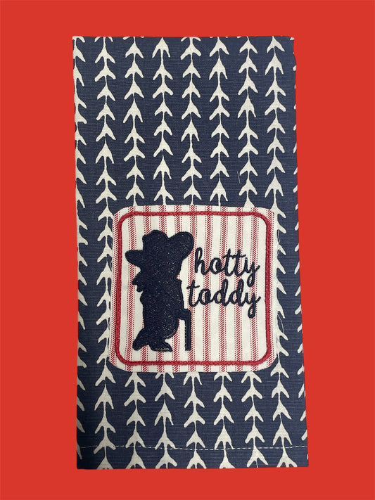 Decorative hand towel featuring embroidered silhouette of Colonel Reb with "hotty toddy" text on red and white striped patch, set on a navy blue arrow-patterned background, perfect for Ole Miss Rebels fans and collegiate decor.