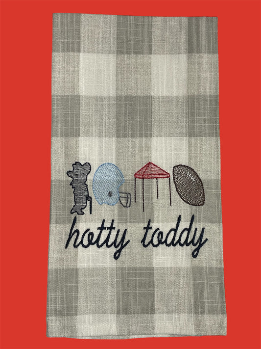Decorative hand towel featuring embroidered Hotty Toddy design with Colonel Rebel, football helmet, tent, and football on a neutral plaid background, perfect for Ole Miss tailgating and football season decor.