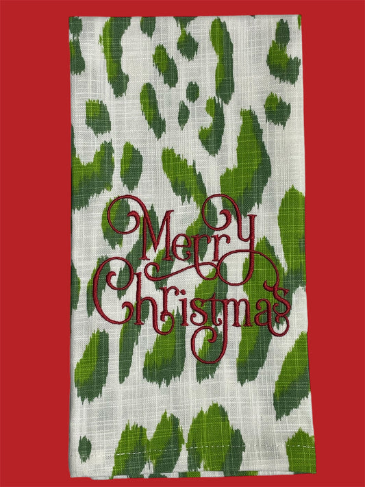 Christmas towel with green leopard print background and "Merry Christmas" embroidered in red script, festive holiday decor.