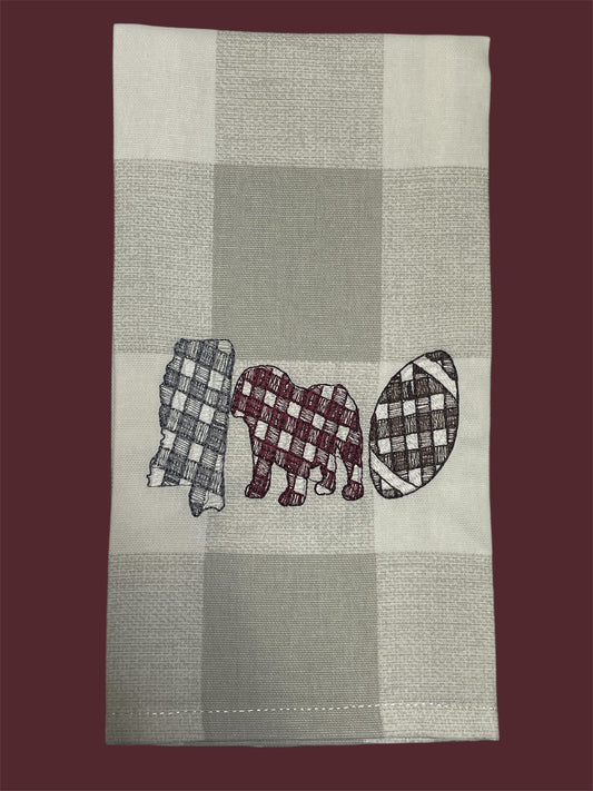 Decorative hand towel featuring embroidered Mississippi state outline, elephant, and football design in gingham patterns on neutral plaid background, perfect for Alabama fans and football-themed kitchen or game day decor.