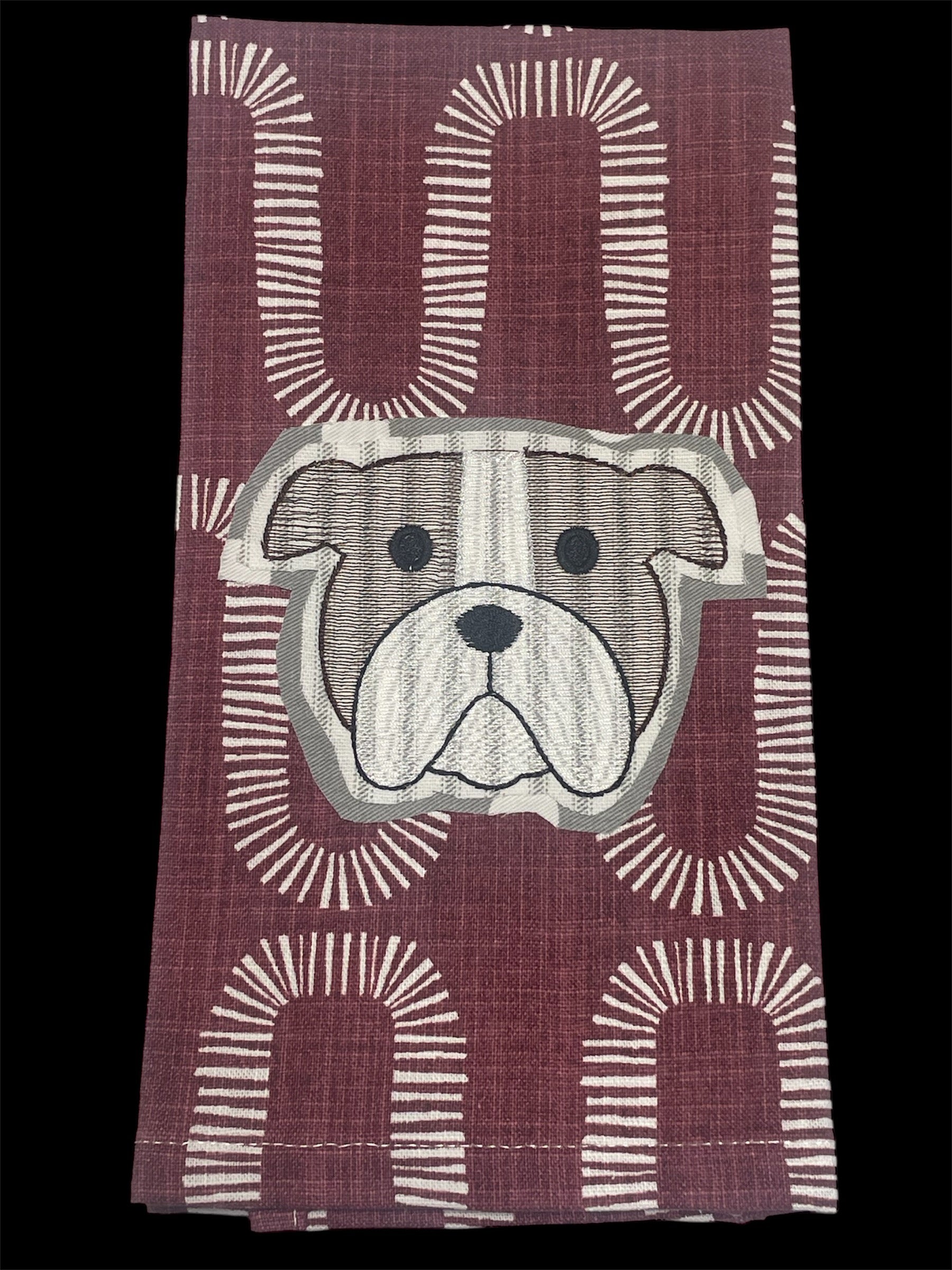 Decorative hand towel featuring embroidered Mississippi State University bulldog mascot on maroon patterned background, perfect for MSU fans and game day decor.