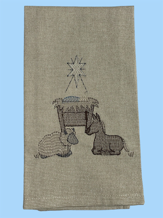 Decorative hand towel featuring embroidered nativity scene with manger, star, donkey, and lamb, perfect for Christmas and holiday seasonal decor.