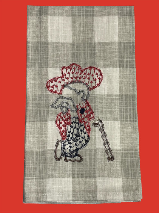 Decorative hand towel featuring stitched design of Colonel Rebel mascot in red, navy, and white pattern on a neutral plaid background, perfect for Ole Miss fans and Southern decor.