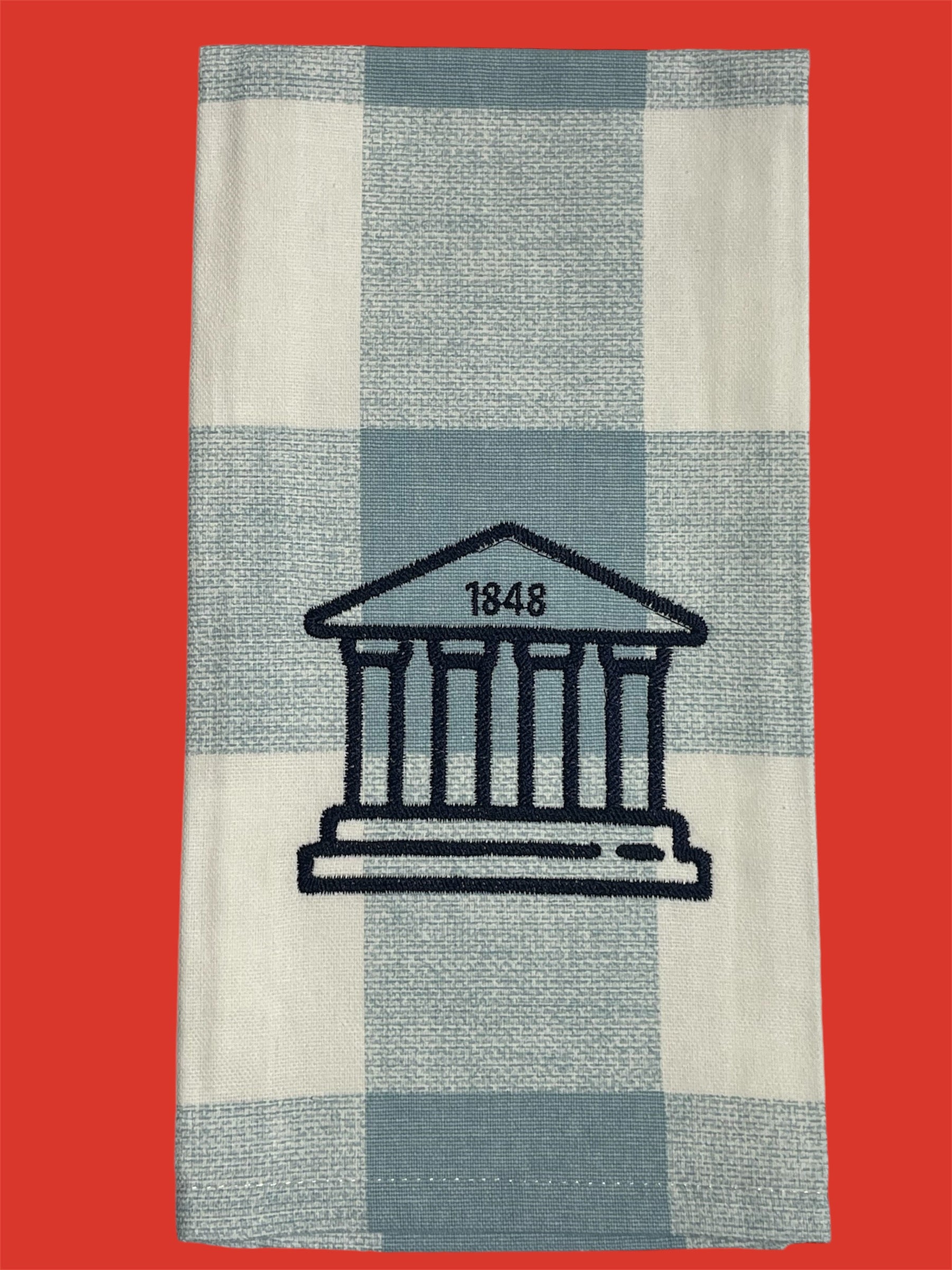 Decorative hand towel featuring embroidered Ole Miss Lyceum with "1848" detail on light blue and white checkered background, perfect for University of Mississippi fans and Oxford-inspired decor.