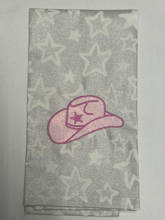 Decorative hand towel featuring embroidered pink cowgirl hat with star and moon detail on silver star-patterned background, perfect for western-themed kitchen decor and gifts.
