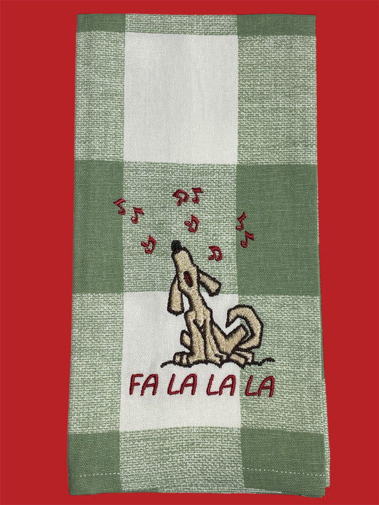 Decorative Christmas hand towel featuring embroidered singing dog with musical notes and "Fa La La La" text on green buffalo check background, perfect for festive holiday kitchen or guest decor.
