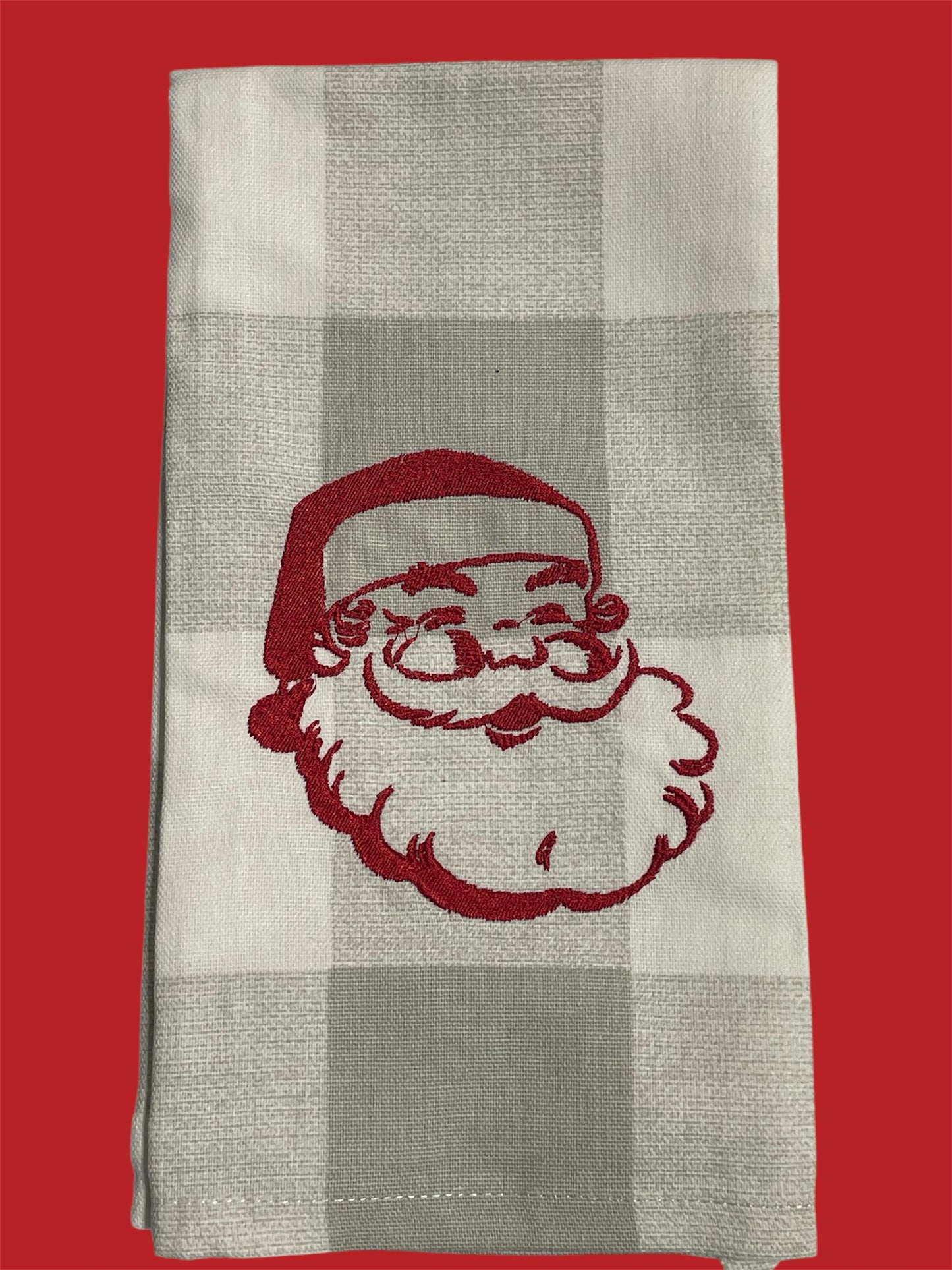 Decorative hand towel featuring embroidered vintage Santa Claus face in red on neutral plaid background, perfect for Christmas holiday kitchen or bathroom decor.