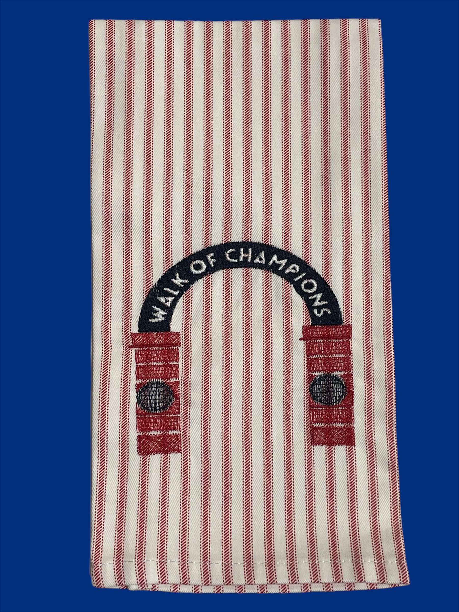 Decorative hand towel featuring embroidered Walk of Champions archway design on red and white striped fabric, representing Ole Miss tradition, ideal for tailgates, kitchens, or game day decor.