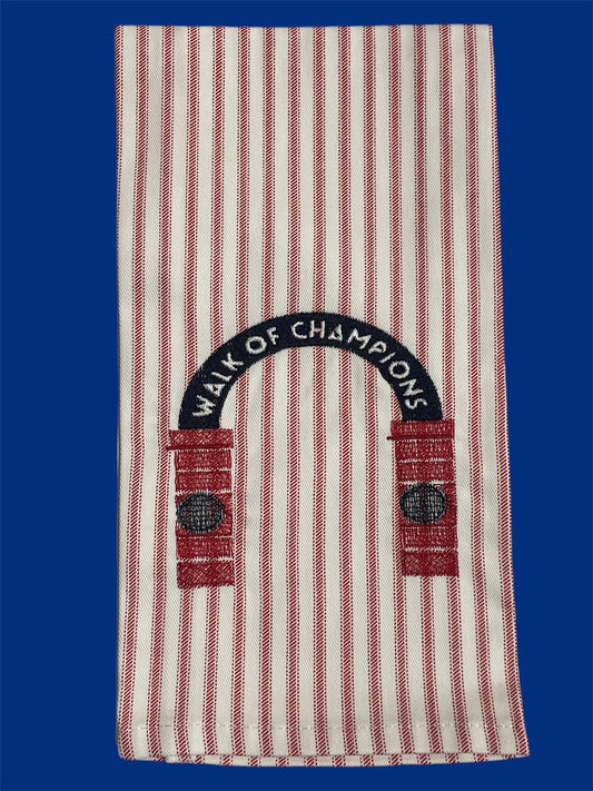 Decorative hand towel featuring embroidered Walk of Champions archway design on red and white striped fabric, representing Ole Miss tradition, ideal for tailgates, kitchens, or game day decor.